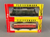 two boxed boxes of toy trains sitting on top of each other