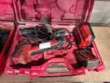 a red tool box with tools in it on the floor