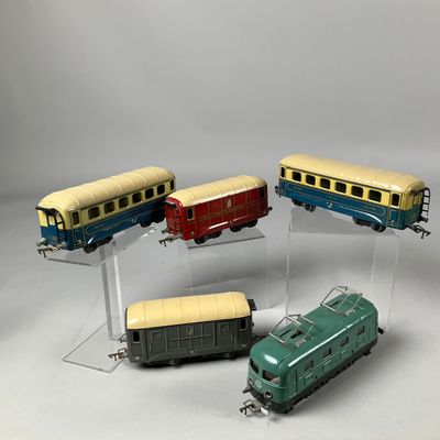 four toy trains sitting on display on a clear stand