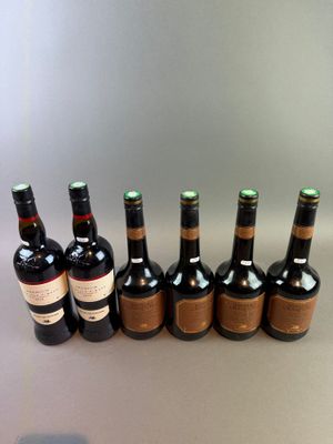 several bottles of wine are lined up in a row on a table