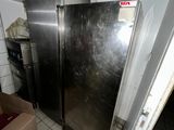 a refrigerator in a kitchen with a basket on top of it