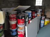 several cans of paint are stacked on top of each other in a room