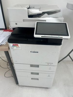 a printer sitting on top of a desk next to a printer