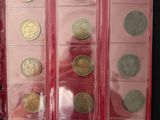 a lot of coins in a red case on a table