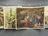 Plusieurs tableaux représentant des personnes sont suspendus à une corde à linge dans une pièce.