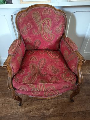 pink paisley upholstered chair with wood frame and arms
