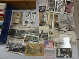 a lot of old photos and postcards on a table