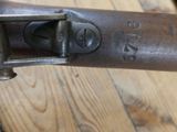 a close up of a gun on a wooden floor