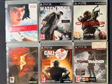four video games in the case on the table