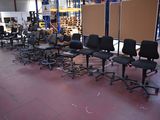 a lot of chairs and tables in a warehouse