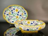 yellow, blue, and green bowl and plate set on a black surface