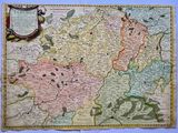an old map of the country of france with a bottle of wine
