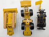 three toy vehicles that are sitting next to each other