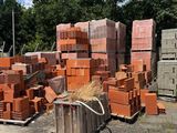un tas de briques posé par terre à côté d'un tas de foin
