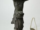 a statue of a woman holding a bowl on her head