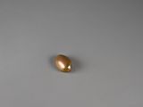 a close up of a golden egg on a gray surface