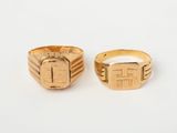 two gold rings, one with a cross and the other with a square design