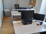 a desk with two computers and a laptop on it