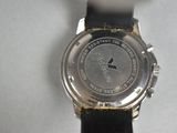 a close up of a watch on a white surface