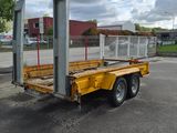 a yellow flatbed truck parked in a parking lot