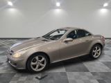 a picture of a silver sports car parked in a garage