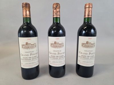 three bottles of wine sitting on top of a table next to each other