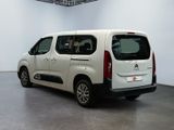 the small white van is parked in a large room