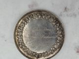 a close up of a silver coin on a marble surface