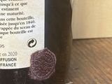 une bouteille de vin posée sur une table, avec une étiquette dessus