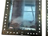 two pictures of a mirror with holes in it