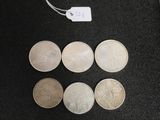 six different types of coins on a black surface with a price tag