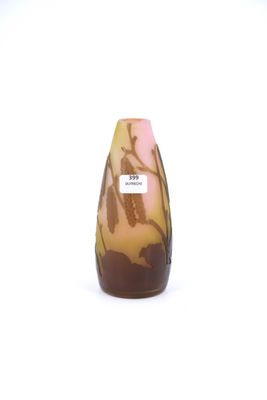 a small vase with a brown and pink design on it