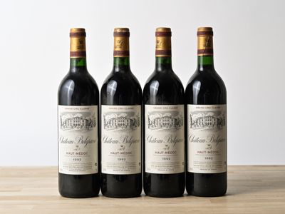 three bottles of wine are lined up on a wooden table