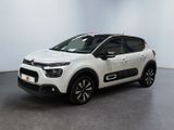 une Citroën blanche garée dans une pièce blanche