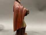 statue of a man in a red robe and a man in a red cloak