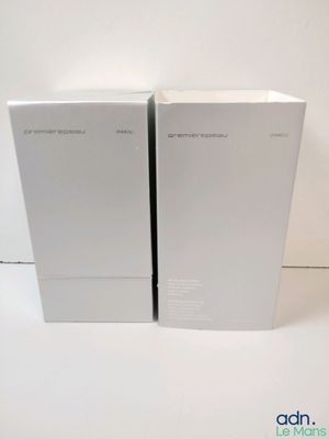two white boxes sitting next to each other on a white surface