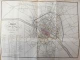 an old map of a city on a piece of paper on a table