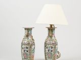 pair of chinese vases with flowers and birds on them with a white shade