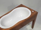 a wooden table with a white bath tub on it