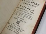 un livre ouvert posé sur une table blanche près d'une fenêtre