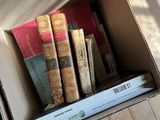a cardboard box with books in it on the floor