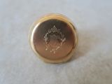 a close up of a gold ring with a crown on it