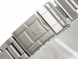 a close up of a watch on a white surface