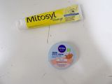 a tube of toothpaste next to a tube of toothpaste