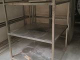 a metal shelf in the middle of a room