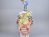 a sculpture of a man with a bird on top of his head