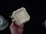 a person holding a small bowl in their hand