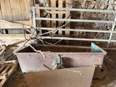 a pile of wood in the middle of a barn