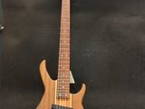 a close up of a bass guitar on a stand on a table