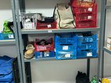 a shelf with baskets and other items on it in a room